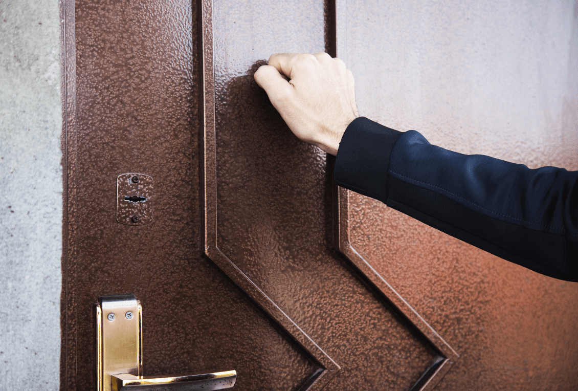 Hand knocking on door